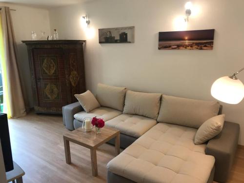 a living room with a couch and a table at Wohnung am See in Steinbach am Attersee