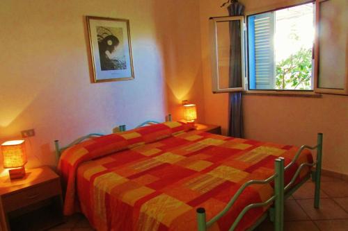 a bedroom with a bed with a checkered blanket at Iocchedda in Porto Ottiolu