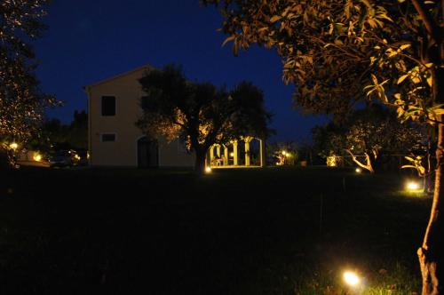 a house with lights in a yard at night at Agriturismo MonteMaggio in Lapedona
