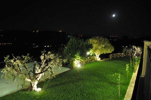 a garden at night with lights on the grass at Agriturismo MonteMaggio in Lapedona