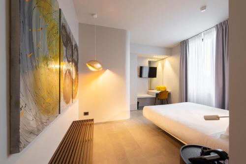 a hotel room with a bed and a tv at Le Funi Hotel in Bergamo