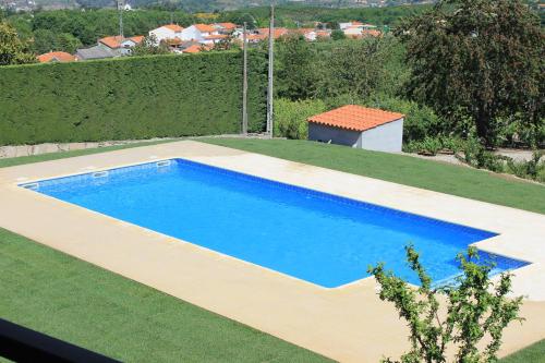 a swimming pool on top of a field of grass at Casa do Batista in Britiande