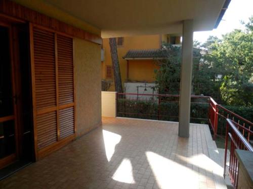 a balcony of a house with the sun shining on it at VILLA ORATA 8b in Principina a Mare