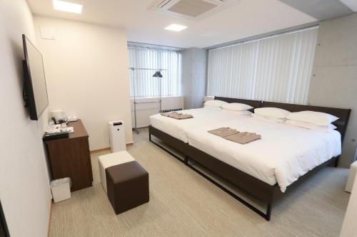 Postel nebo postele na pokoji v ubytování ビジネスカプセルホテル Lightning Hotel浅草