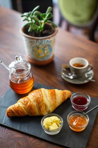 a table with a plate of bread and a cup of coffee at The Frogs_Guest House in Athens
