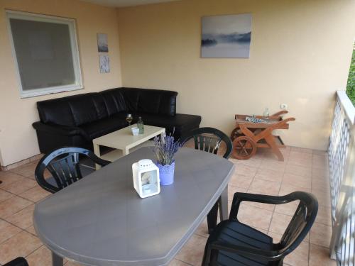 a living room with a table and a couch at Akali Apartman in Balatonakali