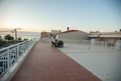 a balcony with chairs and tables on a building at DREAM APPARTMENT 1 PEREA in Perea