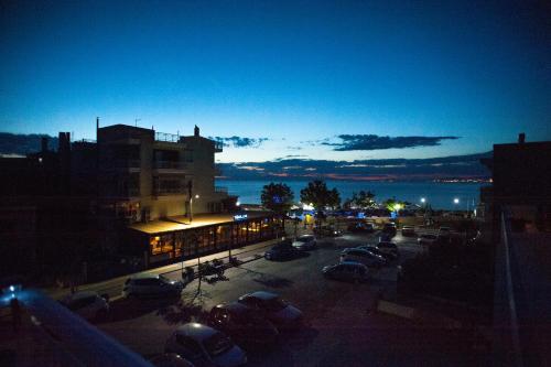 a parking lot with cars parked in front of a building at DREAM APPARTMENT 1 PEREA in Perea