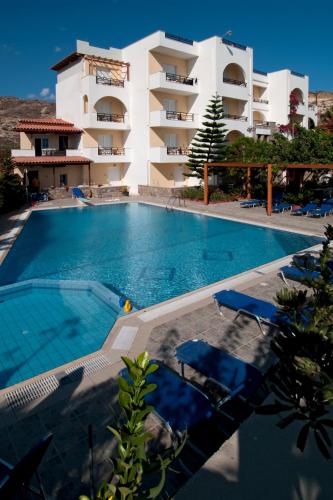 a large swimming pool in front of a building at Sarikampos Beach in Myrtos