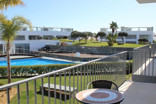 a balcony with a view of a swimming pool at Penthouse Aurélia in Tavira
