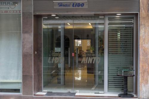 a store front with glass doors in a building at Lido Hotel in Katerini