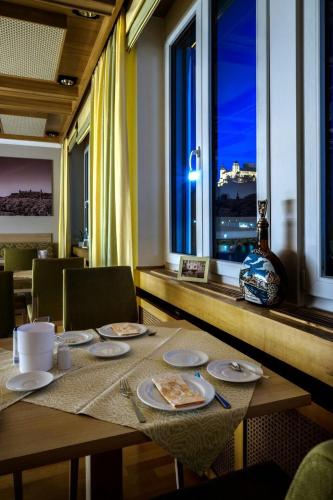 a dining room table with a view of the city at Hotel Alter Kranen in Würzburg
