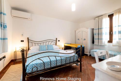 a bedroom with a bed and a table in a room at Villa Vitto - Sleep & Go in Capoterra