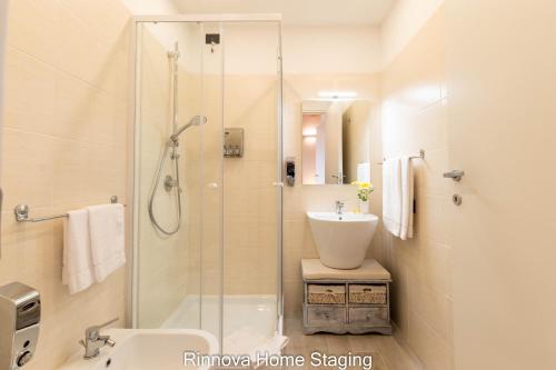 a bathroom with a shower and a sink and a toilet at Villa Vitto - Sleep & Go in Capoterra