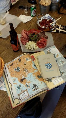 a wooden table with food and a bottle of beer at DonQuihotel Chalet in Karvounádhes