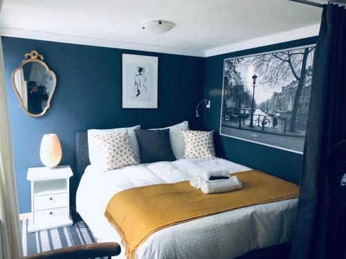 a bedroom with a bed with a blue wall at Casa Blanca Zandvoort in Zandvoort