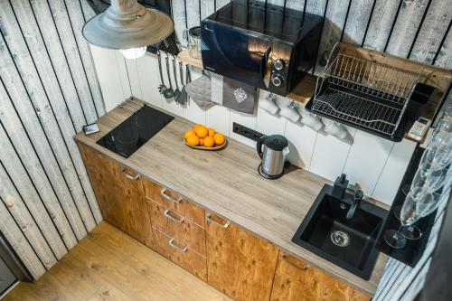 an overhead view of a kitchen with oranges on a counter at Jūras Krasti Bohemija in Jūrmalciems