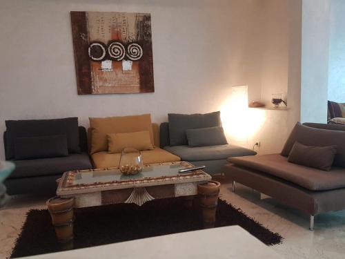 a living room with two couches and a coffee table at home zen in Rabat