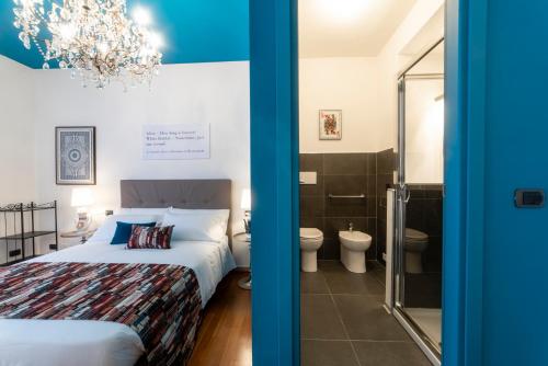 a hotel room with a bed and a mirror at Bibliò Rooms Guesthouse in Bologna