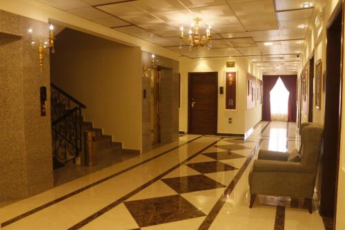 a hallway with a checkered floor in a building at Bissau Royal Hotel in Bissau