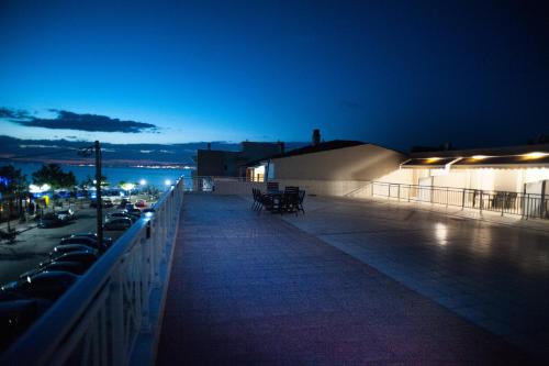 a night view of a balcony with a building and cars at DREAM APPARTMENT 2 PEREA in Perea