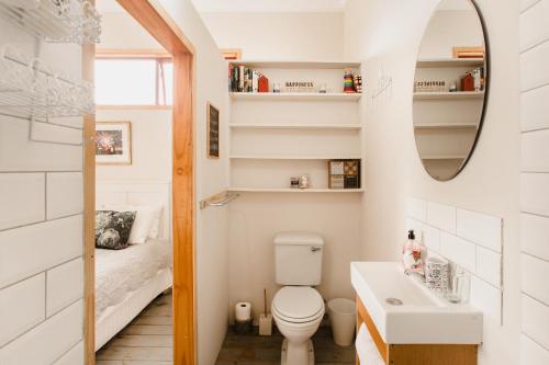 małą łazienkę z toaletą i umywalką w obiekcie The Amberley Annex w mieście Muizenberg