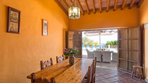a dining room with a wooden table and chairs at Casinhas Wheelchair friendly in Boliqueime