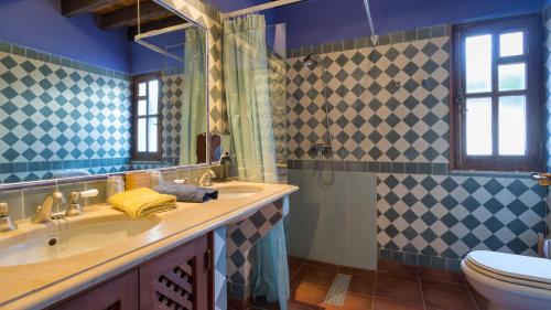 a bathroom with a sink and a toilet at Casinhas Wheelchair friendly in Boliqueime