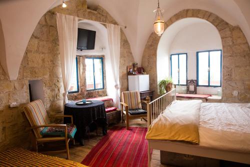 a bedroom with a bed and a table and chairs at Mikes Khan in Abū Ghaush