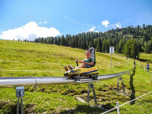 a man riding a ride on a roller coaster at Apartments Bergblick in Sonnenalpe Nassfeld