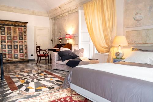 a bedroom with a bed and a living room at Grand Tour Resort in Pisa