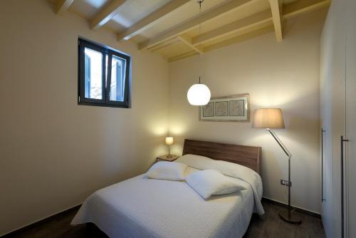 a bedroom with a bed with two pillows and a window at Villa Kalypso in Halki