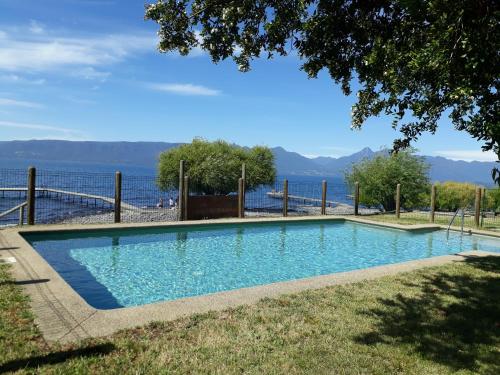 una piscina con vista al agua en CABAÑAS TUNKELEN, en Pucón
