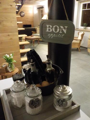 a display of bottles and jars in a room at La petite Juliette in Leuze-en-Hainaut