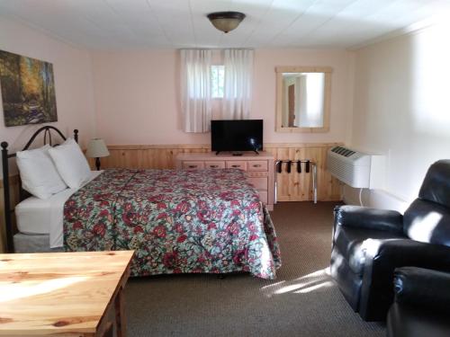 a hotel room with a bed and a couch at Riverbend Lodging in Bryson City
