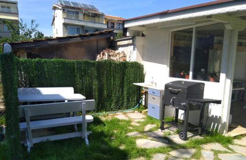 a grill and smoker in the backyard of a house at Family Hotel Malibu in Chernomorets
