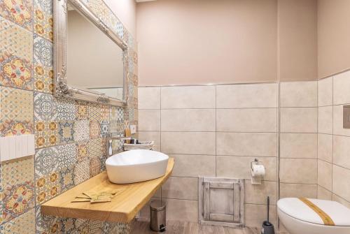 a bathroom with a sink and a toilet at B&B da Chiara in Tortolì