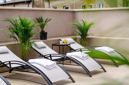 a row of tables and chairs on a balcony at Villa Brandestini in Pula