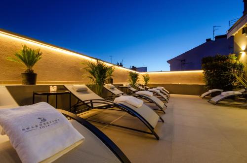 a row of chairs and tables on a balcony at Villa Brandestini in Pula