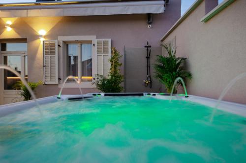 a swimming pool in front of a house at Villa Brandestini in Pula
