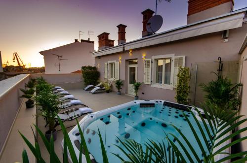 a balcony with a hot tub on a house at Villa Brandestini in Pula