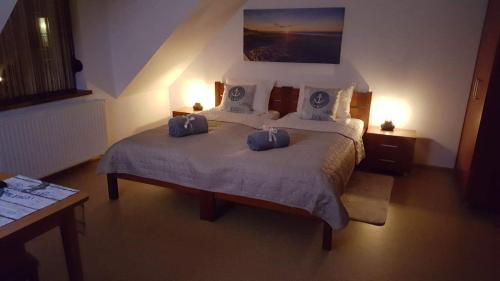 a bedroom with a bed with two bags on it at Villa Kapitańska in Kołobrzeg