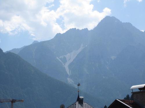 a mountain with a cross on top of a building at Ferienwohnung Lienz Egger in Lienz
