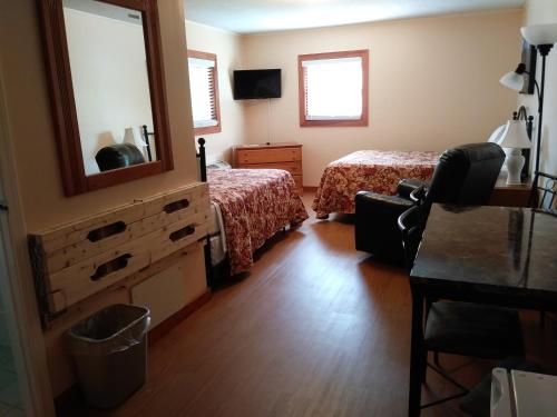 a bedroom with two beds and a mirror at Riverbend Lodging in Bryson City