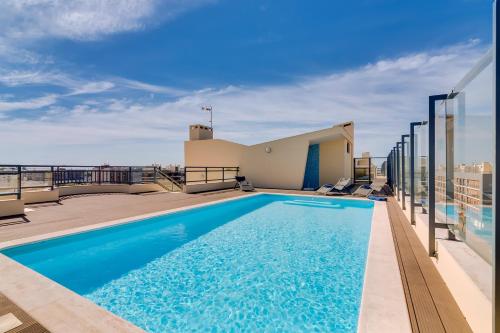 a swimming pool on the roof of a building at Ria House - beautiful apartment with swiming pool in Olhão