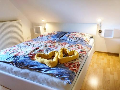 a bed with two pairs of shoes on it at 2 studio & apartment Cvetek Bohinj in Bohinj