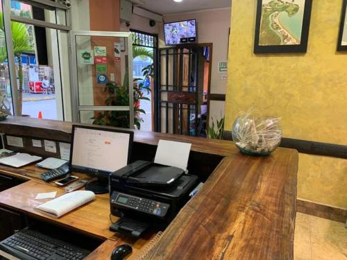 an office with a desk with a computer on it at Hotel La Barca in Atacames