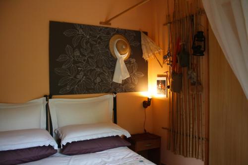 a bedroom with two beds and a picture on the wall at Mini suite alla Cascata in Noci