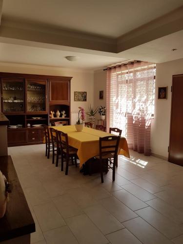 a dining room table and chairs in a kitchen at B&B la casetta di Lilly in Amelia