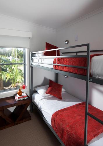 a bedroom with two bunk beds and a window at BIG4 Gold Coast Holiday Park in Gold Coast